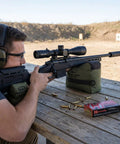 Man using Pre Filled All Weather Rifle Sandbag Rest For Bench Shooting And Competition Front And Rear Set Ready To Use Heavy Duty 900D Oxford Fabric Tear Resistant Olive Drab.