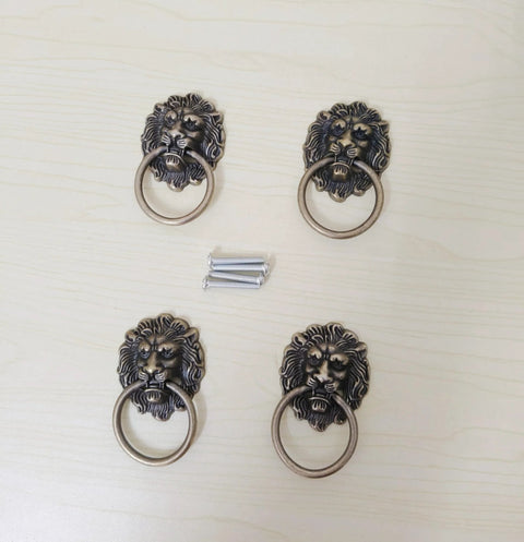 Antique Bronze Lion Head Ring Pull Cabinet Handles Set Of 4 With Screws, 2.6 Inches Long By 1.6 Inches Wide on light surface