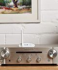 Long Range Bluetooth 5.3 Music Receiver with Audiophile DAC on silver stereo amplifier in home setting