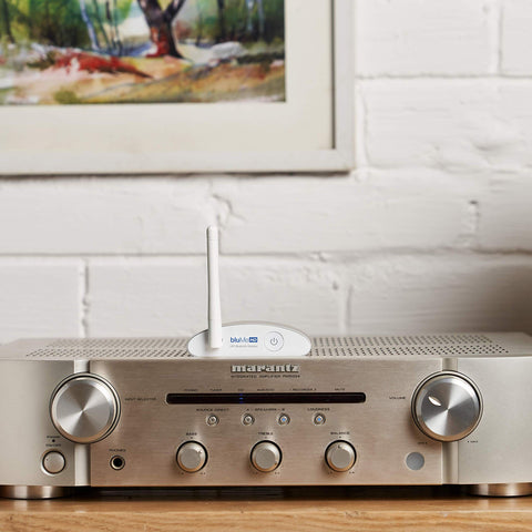 Long Range Bluetooth 5.3 Music Receiver with Audiophile DAC on silver stereo amplifier in home setting