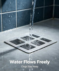 Water flowing over an 80Pcs 4x4 Disposable Hair Drain Stickers Anti Blocking drain cover, preventing clogs.
