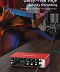 Beginner USB Audio Interface With 24Bit 192kHz Studio Grade Sound 48V Phantom Power Plug And Play on desk with guitar