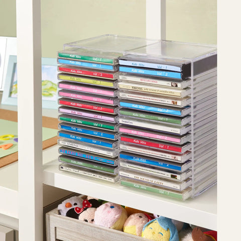 Stackable Clear Plastic CD Organizer With Rubber Feet For Home Theater Or Media Room, Holds Up To 30 Jewel Cases, showing CDs neatly arranged on a shelf.
