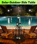 Must-Have Outdoor Solar Coffee Table With Light Black Iron 52.5 Inch Waterproof End Table For Living Rooms Or Patio Doubles As A Solar Floor Lamp And Plant Stand For Backyard Poolside Decor by a swimming pool with lounge chairs.