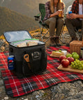 Plug In Electric Portable Cooler And 12V Car Fridge 14 Quart Capacity Soft Sided Travel Bag For Camping And Road Trips Keeps Your Grub And Drinks Ice Cold Zero Hassle Required Extra Pockets Plus Folds Flat at a picnic with food.
