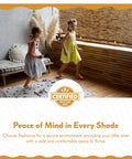 Two children playing indoors near wooden blinds, highlighting Cordless Bamboo Blinds Waterproof Roller Shades For Porch And Patio Roll Up Bamboo Shades For Inside Mount Indoor And Outdoor Privacy Screen In Cocoa 48 By 72 Inches.
