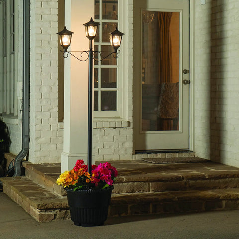 Triple Head Solar Lamp Post Set With Round Planter, Weather Resistant Outdoor Lighting In Black Finish at night