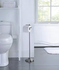 Bathroom scene with a Free Standing Toilet Paper Roll Holder With Reserve Storage, Black Nickel finish, located near a toilet.