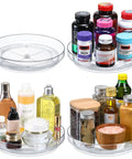 Four Pack 9 Inch Clear Acrylic Lazy Susans Non Skid Turntables Organizer For Cabinets Kitchen Pantry Refrigerator Vanity Countertop And Spice Rack Rotating Storage To Maximize Space And Accessibility with medicines, oils, and spices displayed.