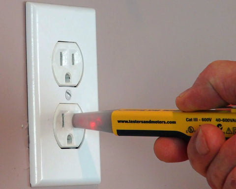 Top Shelf Non Contact Voltage Tester Picks Up 40 To 600 Vac used on wall outlet with clear LED display for electricians.