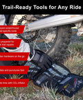 Compact Trail Saver Motorcycle Tool Kit With Axle Wrench 22mm And 27mm Puncture Repair Kit shown by a motorbike tire