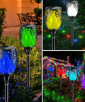 Outdoor RGB Solar Flame Lights 4 Pack With Seven Color Flickering Fire Effect illuminating a garden at night