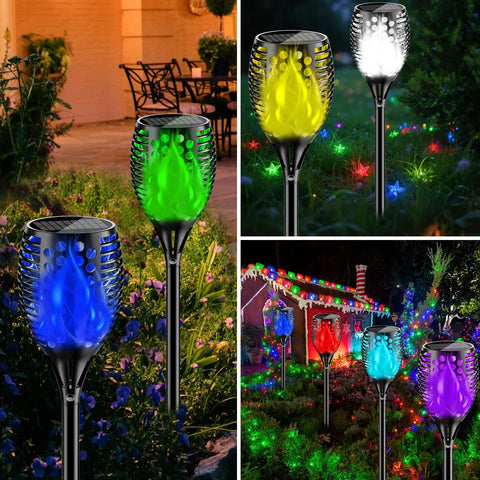 Outdoor RGB Solar Flame Lights 4 Pack With Seven Color Flickering Fire Effect illuminating a garden at night