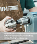 Worker using lathe spindle adapter for woodworking converts one and a quarter inch 8TPI female to one inch 8TPI male.