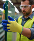 Man wearing Kevlar Tough Cut Resistant Work Gloves With PVC Grip ANSI Rated Heavy Duty Safety Gear For Glass Handling