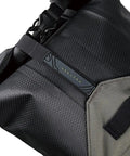 Close-up of BackLoader X Bike Bag 15L for Bikepacking in Green, waterproof and durable materials, showing secure strap detail.