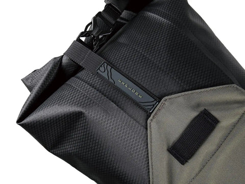 Close-up of BackLoader X Bike Bag 15L for Bikepacking in Green, waterproof and durable materials, showing secure strap detail.