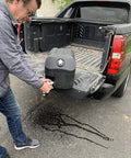 Man pouring from Road Ready Heavy Duty Portable Hand Washing Station Featuring A Roomy 6.6 Gallon Water Tank And No Fuss Soap Dispenser.