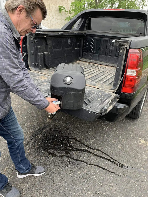 Man pouring from Road Ready Heavy Duty Portable Hand Washing Station Featuring A Roomy 6.6 Gallon Water Tank And No Fuss Soap Dispenser.