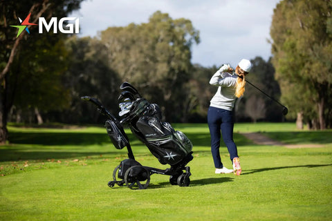 Solid As A Rock Electric Golf Cart With Remote Seat Attachment And Quick Zip Fold Frame For All Terrain Courses Plus Cup Holder And Scorecard Storage Accessories on golf course with player in background.