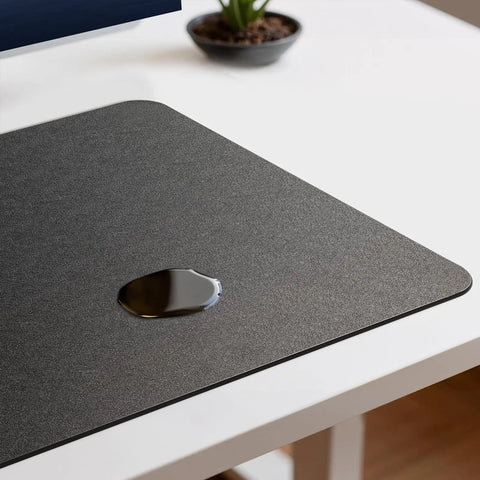 Premium Leather Desk Pad Mat Non Slip Blotter Desk Protector For Office And Home 17 By 12 Inches Shields Your Desk From Scratches Stains And Spills Easy To Clean Perfect For Lap Desks Laptops And Desktops showing a water spill