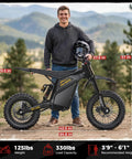 Person standing with Villain 4160W Electric Dirt Bike With 52V 26Ah Battery, showcasing 14 and 12 inch fat tires and dual disc brakes.