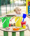 Child playing with Six Pack Kids Beach Buckets And Shovels Set For Outdoor Summer Fun 7 inch large sand pails, sandbox setting