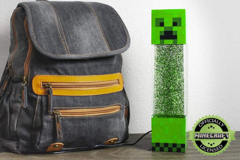 Glitter Creeper Mood Light 12 Inch LED Lamp for Gaming Rooms next to backpack, Minecraft themed night light with glitter glow