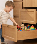 Child exploring toys in a drawer with Smooth As Butter 18 Inch Undermount Drawer Slides Two Pack Soft Close Full Extension Cabinet Hardware.