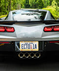 Hella Dope Yellow And Orange Cheese Design License Plate Frames 2 Pack on a silver car, showcasing rear license plate in nature.