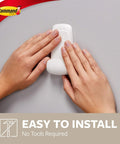 Damage-Free Jumbo Hook Set With 8 Strong Strips being installed by hands, showcasing easy no-tools setup on a wall.