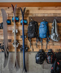 Kickin Sweet Indoor Ski And Snowboard Wall Mount With Rock Solid Damage Free Grip For Garage Storage Holds Boards Poles Safe In Space Saving Premium Gear Rack Cyan Single Pack mounted on a wooden wall.