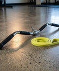 Lat Bar Cable Machine Attachment With Full Rotation Rubber Grip 30 Inch Pulldown Bar on gym floor