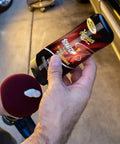 Person holding a bottle of Scratch-X Car Scratch Remover For Fine Scratches And Blemishes Quick Fix Restores Clarity On Glossy Exterior Paint And Clear Coats Ideal For Trucks And SUVs 7 Oz Bottle next to a vehicle.