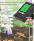 All In One 6 In 1 Soil Tester With pH Meter And LCD Display Measures Soil Moisture Temperature Humidity And Fertility For Gardening Lawn Farm And Outdoor Plants shown in use with garden plants