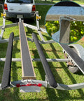 Image showing 8 Pack Heavy Duty Swivel Top Angle Brackets For Boat Trailers mounted on a trailer for secure marine bunk support.