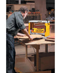 Heavy Duty 12.5 Inch Benchtop Wood Thickness Planer in use, shaving wood on a workbench for precise furniture crafting.