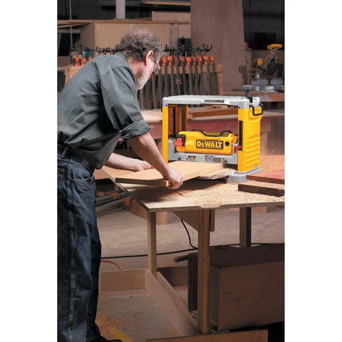 Heavy Duty 12.5 Inch Benchtop Wood Thickness Planer in use, shaving wood on a workbench for precise furniture crafting.