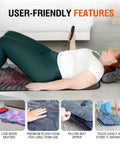 Person using Full Body Massage Mat With Heat And Shiatsu Vibration for pain relief in bed, featuring low-noise motors and folding design.
