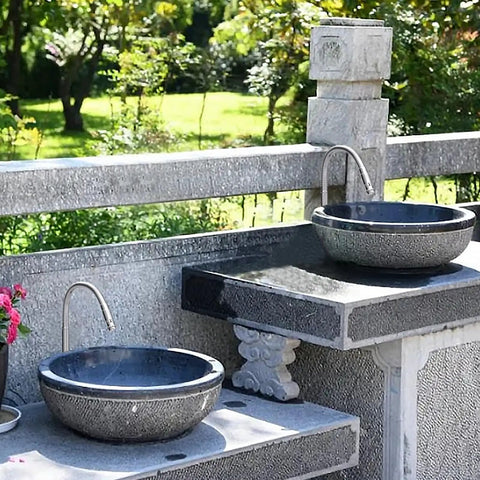 Outdoor kitchen sink faucet, 360 degree rotatable, deck mounted, single hole, single handle cold water tap in a garden setting.