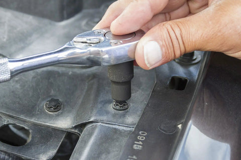 Hand using ratchet with External Torx Plus Socket Set Go-To Nine-Piece For Automotive Jobs on vehicle panel