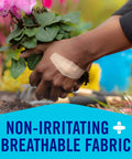 Close-up of hand wearing Painless-Removal Bandage during gardening, focus on breathable fabric and strong adhesive.