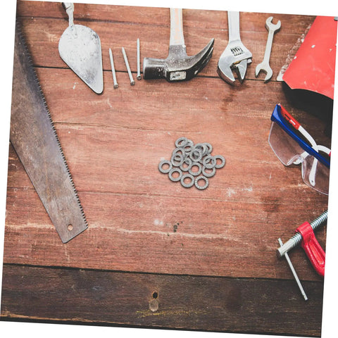 Top Shelf Tapered Lock Washers For M10 Manganese Steel 20 Pack on a wooden workbench with tools and safety glasses.