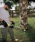 Person using Replacement Trimmer Head DWO1DT995 For Dewalt Cordless String Trimmers With Bump Feed in yard work setting