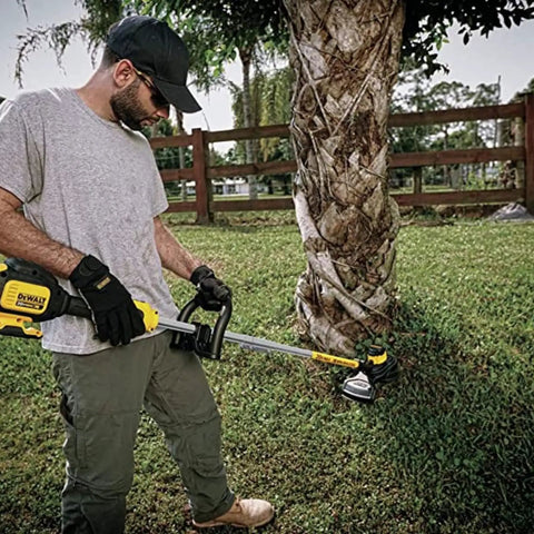 Person using Replacement Trimmer Head DWO1DT995 For Dewalt Cordless String Trimmers With Bump Feed in yard work setting