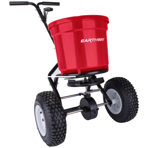 Heavy Duty 50 Lb Broadcast Fertilizer Spreader For Lawns, Walk Behind Push Seeder, shown with large 13 inch pneumatic tires.
