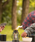 Tabletop Metal Torch Lanterns Two Pack for Outdoor Patio Garden and Backyard adding warmth to card game setting on table.