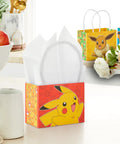 Pokemon Mini Gift Bags 18 Pack With Handles For Birthday Parties And Classroom Treats Featuring Pikachu Charizard Eevee And Gengar Designs About 5 Inches Wide By 4 Inches High By 3 Inches Deep, Pikachu design on a red bag with handles on a kitchen counter