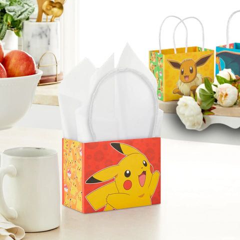 Pokemon Mini Gift Bags 18 Pack With Handles For Birthday Parties And Classroom Treats Featuring Pikachu Charizard Eevee And Gengar Designs About 5 Inches Wide By 4 Inches High By 3 Inches Deep, Pikachu design on a red bag with handles on a kitchen counter