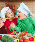 Montessori kids knife set with wooden toddler knives and green handles, kids cooking with vegetables.